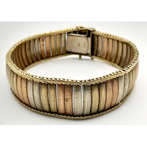 22 - A Vintage 9K Gold Tri-Colour Bracelet. Bands of white, rose ang yellow gold. Clip open design. 18cm.... 