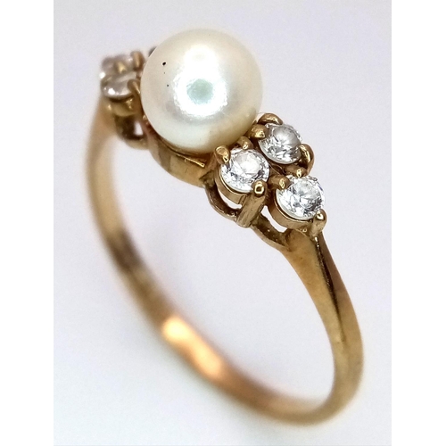 556 - A 9K Yellow Gold Pearl and White Stone Ring. Size K. 1.4g total weight.