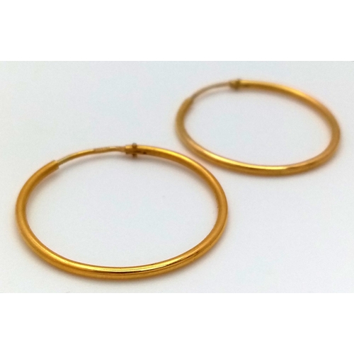 639 - A Pair of Thin 18K Yellow Gold Hoop Earrings. 2g total weight.