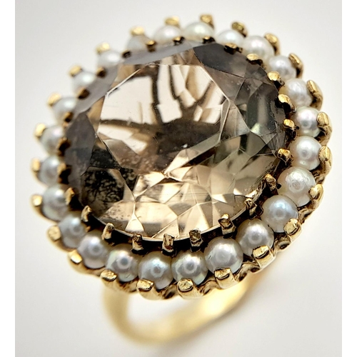 85 - A Vintage 9K Yellow Gold Smoky Topaz and Seed Pearl Dress Ring. A round cut large smoky topaz with a... 