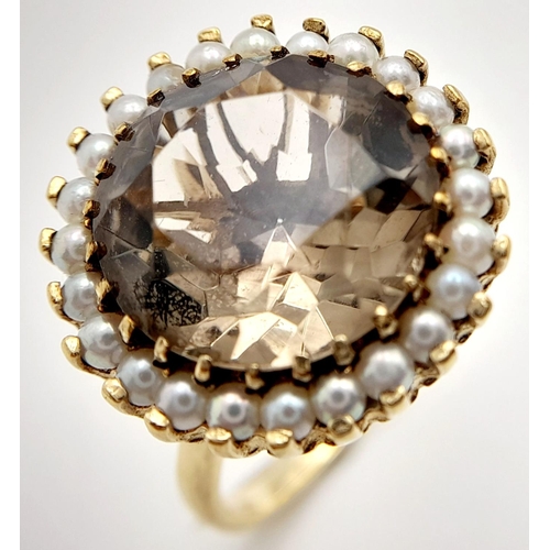 85 - A Vintage 9K Yellow Gold Smoky Topaz and Seed Pearl Dress Ring. A round cut large smoky topaz with a... 