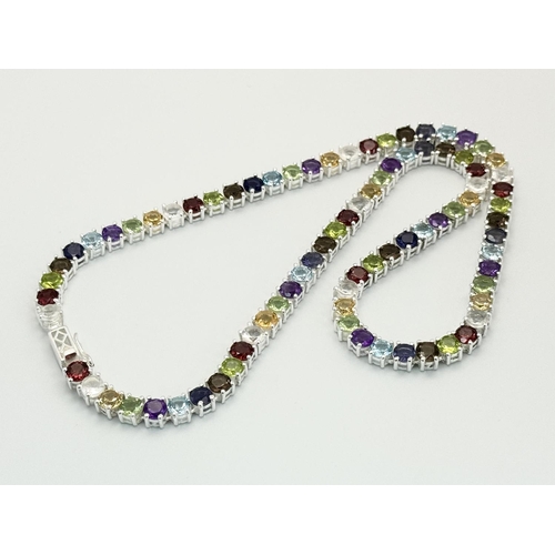 191 - A Multi-Gemstone Necklace. Includes: Amethyst, Garnet, Peridot and Topaz. Set in 925 silver. 44cm. R... 