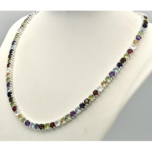 191 - A Multi-Gemstone Necklace. Includes: Amethyst, Garnet, Peridot and Topaz. Set in 925 silver. 44cm. R... 