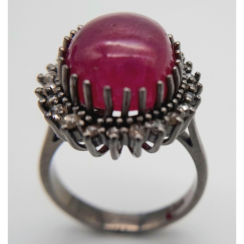 331 - A Ruby Cabochon Gemstone Ring with Diamond Surround. Ruby - 8ct. Diamonds - 0.40ctw. Set in 925 Silv... 