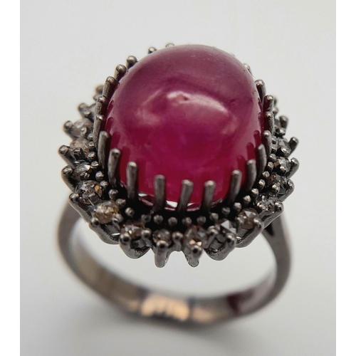 331 - A Ruby Cabochon Gemstone Ring with Diamond Surround. Ruby - 8ct. Diamonds - 0.40ctw. Set in 925 Silv... 