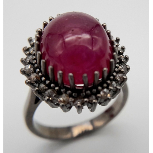 331 - A Ruby Cabochon Gemstone Ring with Diamond Surround. Ruby - 8ct. Diamonds - 0.40ctw. Set in 925 Silv... 