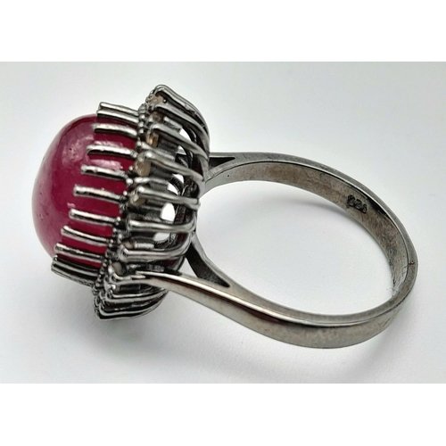 331 - A Ruby Cabochon Gemstone Ring with Diamond Surround. Ruby - 8ct. Diamonds - 0.40ctw. Set in 925 Silv... 