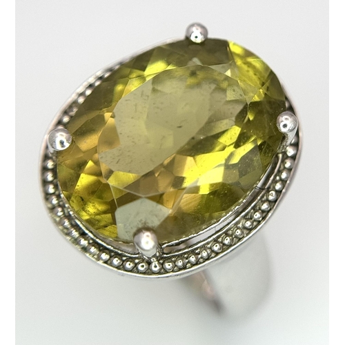 420 - Large oval cut YELLOW TOURMALINE set in a SILVER RING. Having markings for 925 SILVER and TGGC ( The... 