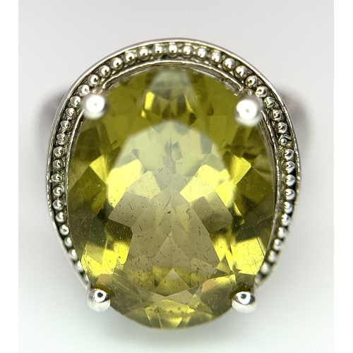 420 - Large oval cut YELLOW TOURMALINE set in a SILVER RING. Having markings for 925 SILVER and TGGC ( The... 