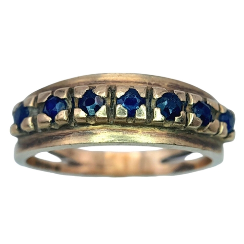 506 - A Vintage 9K Gold Seven Stone Sapphire Ring. Size N 1/2. 3.1g total weight.