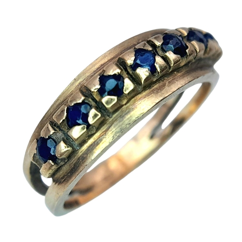 506 - A Vintage 9K Gold Seven Stone Sapphire Ring. Size N 1/2. 3.1g total weight.