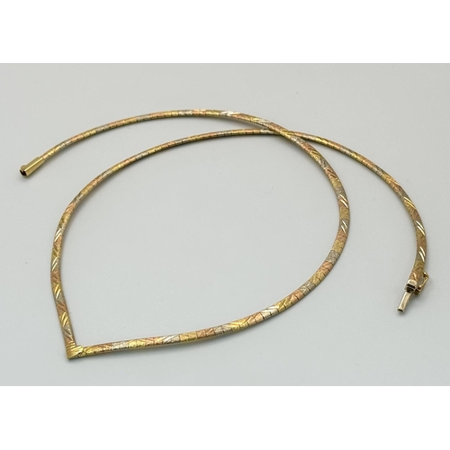 569 - An 18K Yellow, White and Rose Gold Herringbone Necklace. 
38cm. 14.9g.