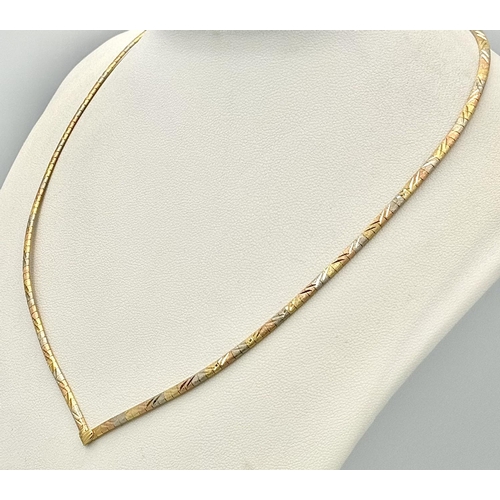 569 - An 18K Yellow, White and Rose Gold Herringbone Necklace. 
38cm. 14.9g.