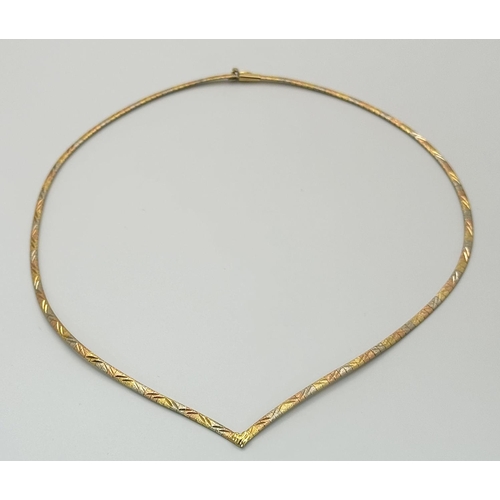 569 - An 18K Yellow, White and Rose Gold Herringbone Necklace. 
38cm. 14.9g.