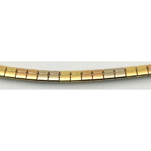 569 - An 18K Yellow, White and Rose Gold Herringbone Necklace. 
38cm. 14.9g.