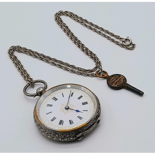 783 - An Antique 935 Silver Small Ladies Pocket Watch on a Sterling Silver Chain (with key). Engraved case... 