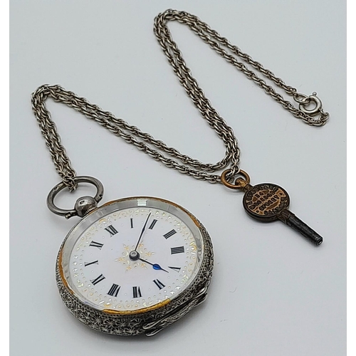 783 - An Antique 935 Silver Small Ladies Pocket Watch on a Sterling Silver Chain (with key). Engraved case... 