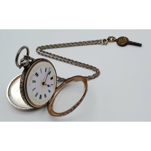 783 - An Antique 935 Silver Small Ladies Pocket Watch on a Sterling Silver Chain (with key). Engraved case... 