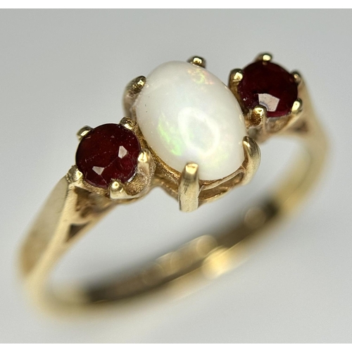 161 - Classic 9 carat GOLD, OPAL and GARNET RING. Having an OPAL CABOCHON set to centre with Round Cut GAR... 