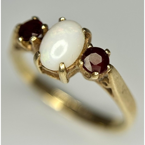 161 - Classic 9 carat GOLD, OPAL and GARNET RING. Having an OPAL CABOCHON set to centre with Round Cut GAR... 