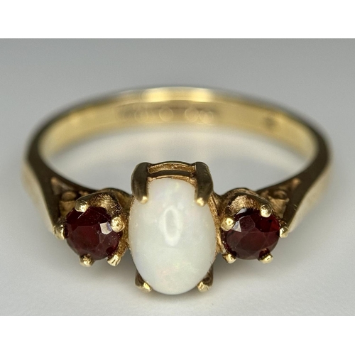 161 - Classic 9 carat GOLD, OPAL and GARNET RING. Having an OPAL CABOCHON set to centre with Round Cut GAR... 