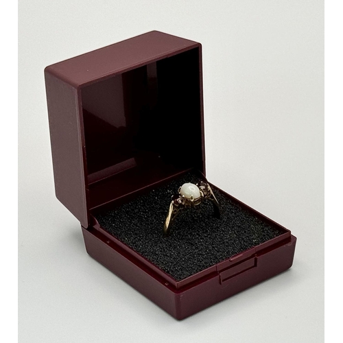 161 - Classic 9 carat GOLD, OPAL and GARNET RING. Having an OPAL CABOCHON set to centre with Round Cut GAR... 