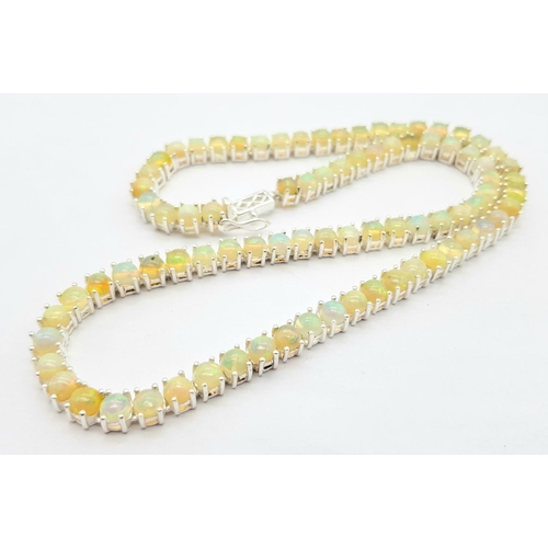 170 - An Ethiopian Opal Gemstone Tennis Necklace. Lovely colour-play. Set in 925 Silver. 44cm length. Ref:... 