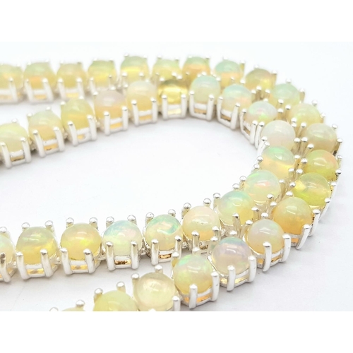 170 - An Ethiopian Opal Gemstone Tennis Necklace. Lovely colour-play. Set in 925 Silver. 44cm length. Ref:... 