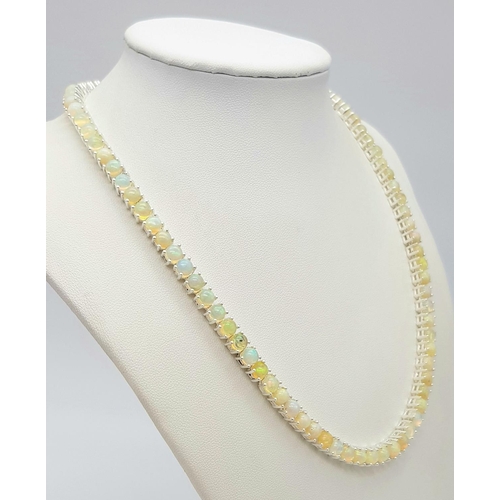 170 - An Ethiopian Opal Gemstone Tennis Necklace. Lovely colour-play. Set in 925 Silver. 44cm length. Ref:... 