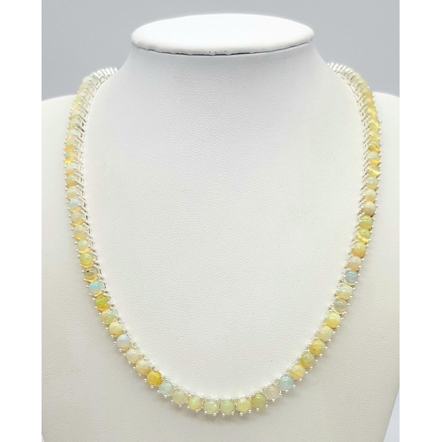 170 - An Ethiopian Opal Gemstone Tennis Necklace. Lovely colour-play. Set in 925 Silver. 44cm length. Ref:... 