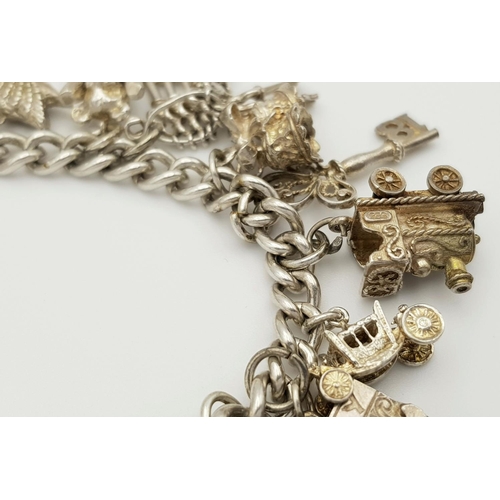 268 - A beautiful vintage Solid Silver 925 Charm Bracelet, with 19 charms, 80 grams, 18cm. In very good co... 