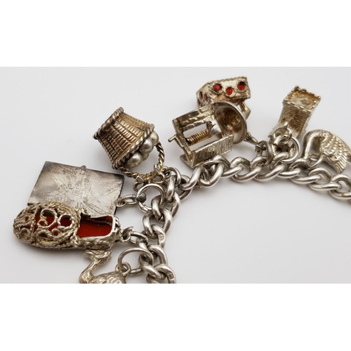 268 - A beautiful vintage Solid Silver 925 Charm Bracelet, with 19 charms, 80 grams, 18cm. In very good co... 