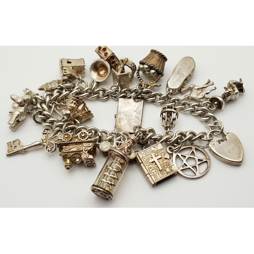 268 - A beautiful vintage Solid Silver 925 Charm Bracelet, with 19 charms, 80 grams, 18cm. In very good co... 