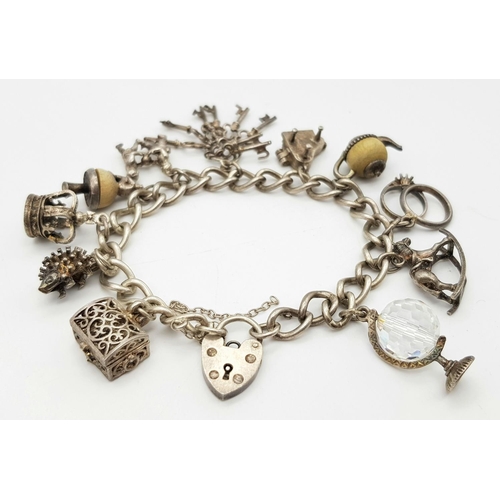 378 - Vintage SILVER CHARM BRACELET complete with safety chain and SILVER HEART PADLOCK. Charms to include... 