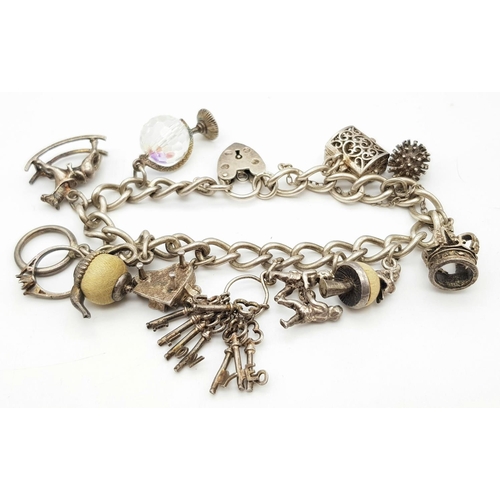 378 - Vintage SILVER CHARM BRACELET complete with safety chain and SILVER HEART PADLOCK. Charms to include... 