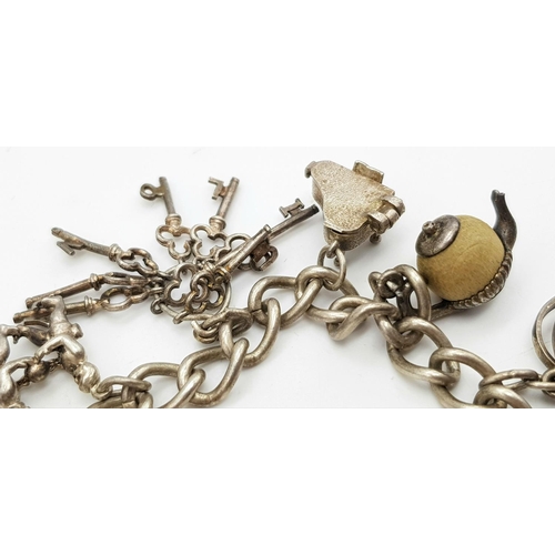 378 - Vintage SILVER CHARM BRACELET complete with safety chain and SILVER HEART PADLOCK. Charms to include... 