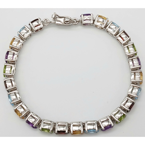 970 - An Oval Cut Amethyst, Peridot and Citrine Gemstone Tennis Bracelet. Set in 925 Silver. 18cm length. ... 