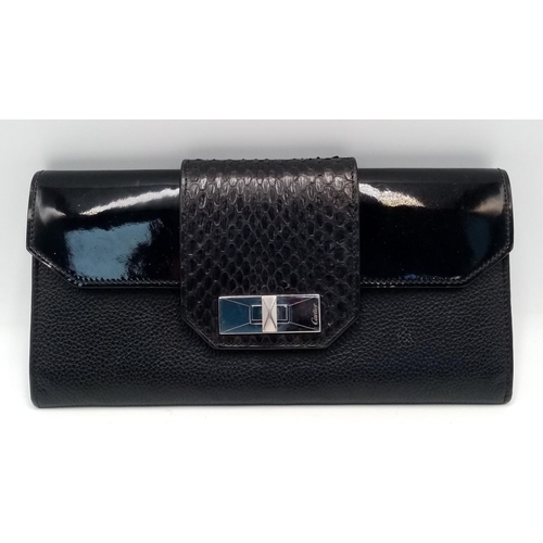 113 - A Cartier Black Purse/Wallet. Snake, leather and patent leather exterior with silver-toned hardware ... 