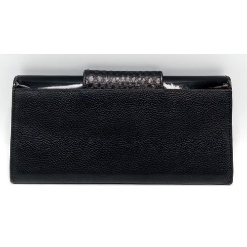 113 - A Cartier Black Purse/Wallet. Snake, leather and patent leather exterior with silver-toned hardware ... 