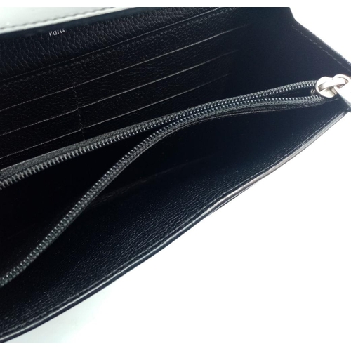 113 - A Cartier Black Purse/Wallet. Snake, leather and patent leather exterior with silver-toned hardware ... 