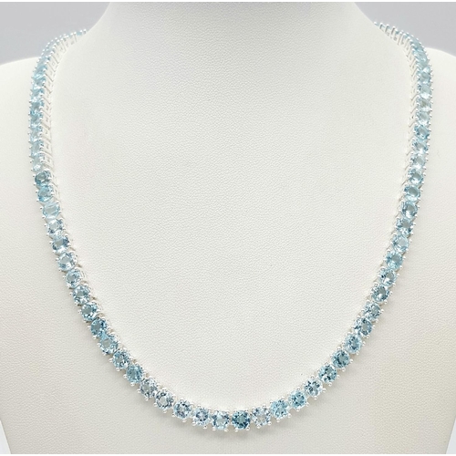 256 - A Blue Topaz Gemstone Tennis Necklace. Set in 925 Silver. 42cm. CD- 1515