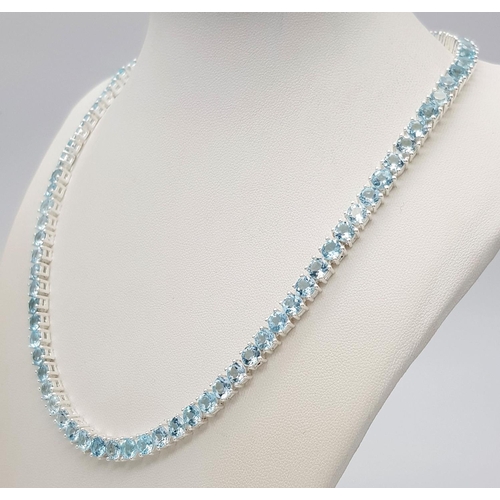 256 - A Blue Topaz Gemstone Tennis Necklace. Set in 925 Silver. 42cm. CD- 1515