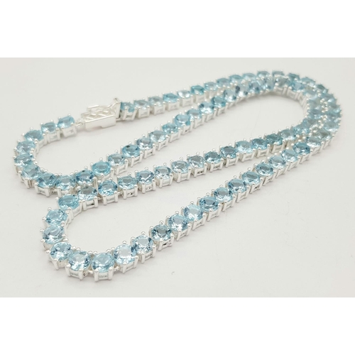 256 - A Blue Topaz Gemstone Tennis Necklace. Set in 925 Silver. 42cm. CD- 1515