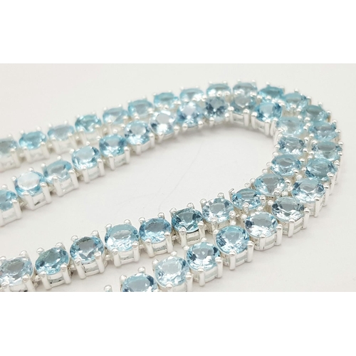 256 - A Blue Topaz Gemstone Tennis Necklace. Set in 925 Silver. 42cm. CD- 1515