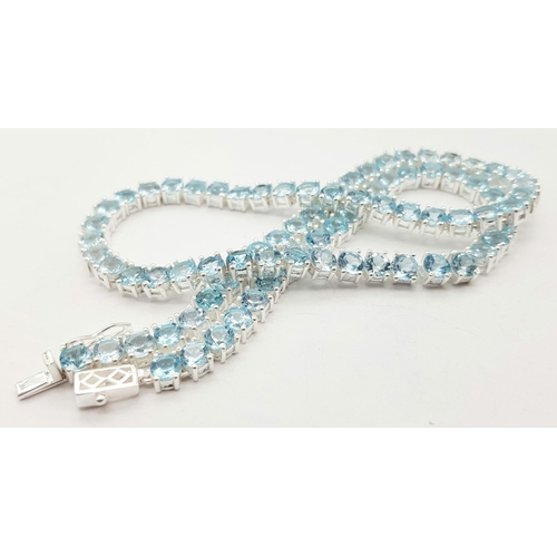 256 - A Blue Topaz Gemstone Tennis Necklace. Set in 925 Silver. 42cm. CD- 1515