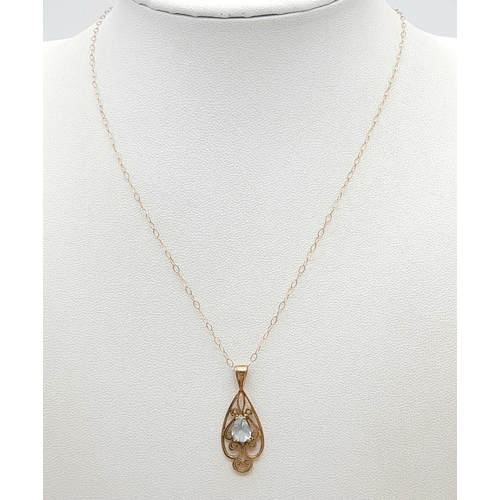 338 - A 9K Yellow Gold Blue Pendant on a 9K Yellow Gold Disappearing Necklace. 3cm and 40cm. 1.37g