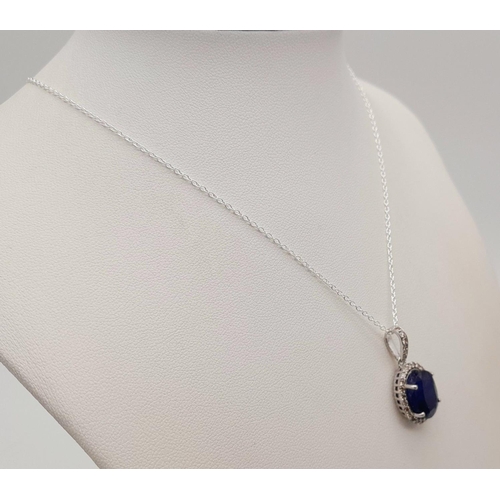 611 - A 6ct Blue Sapphire Pendant with 0.62ctw of Diamond Accents. Set in 925 Silver. 25mm.