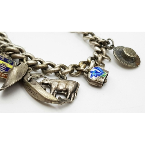 651 - Vintage SILVER CHARM BRACELET. Complete with safety chain . Silver charms from around Europe to incl... 