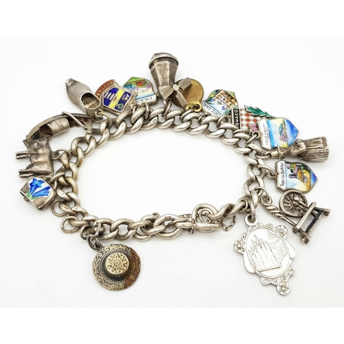 651 - Vintage SILVER CHARM BRACELET. Complete with safety chain . Silver charms from around Europe to incl... 