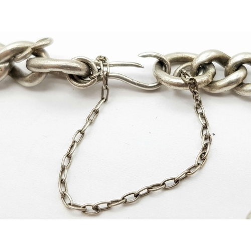 651 - Vintage SILVER CHARM BRACELET. Complete with safety chain . Silver charms from around Europe to incl... 